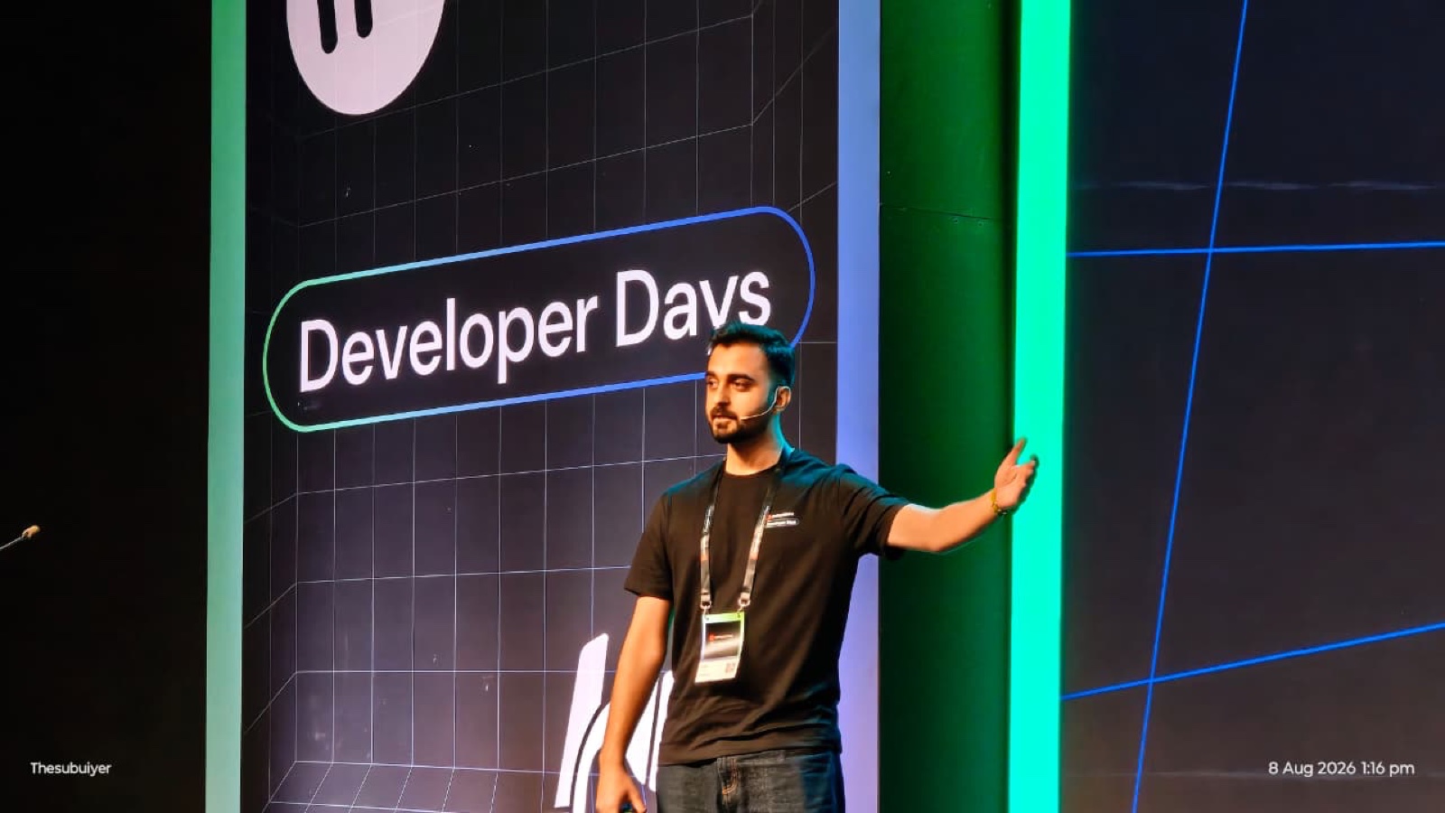Parth Sharma mid-talk on stage, gesturing, headset mic on, Developer Days branding behind him.
