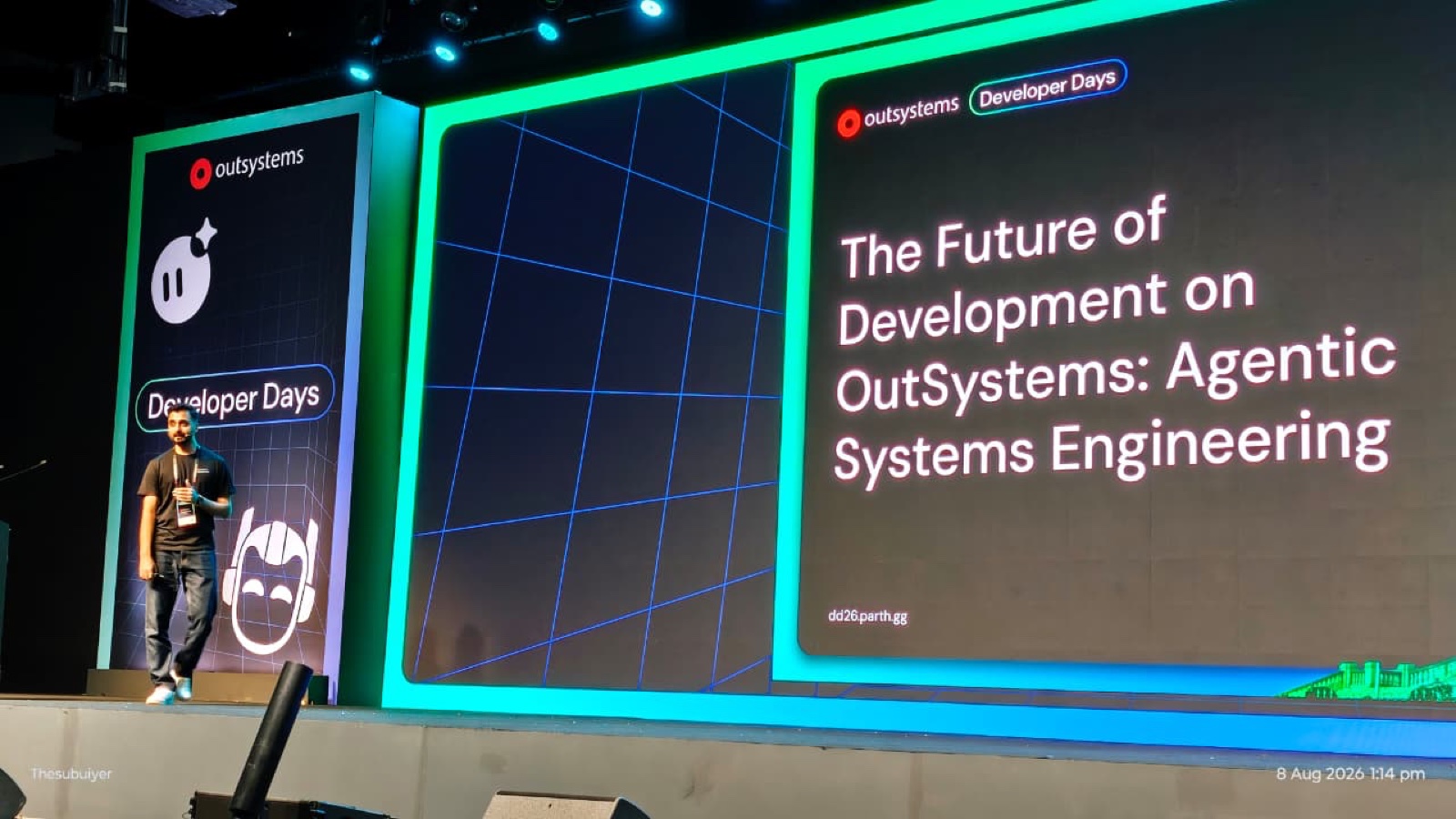 Parth Sharma walking onto the Developer Days Bengaluru stage, title slide 'The Future of Development on OutSystems: Agentic Systems Engineering' on the big screen.